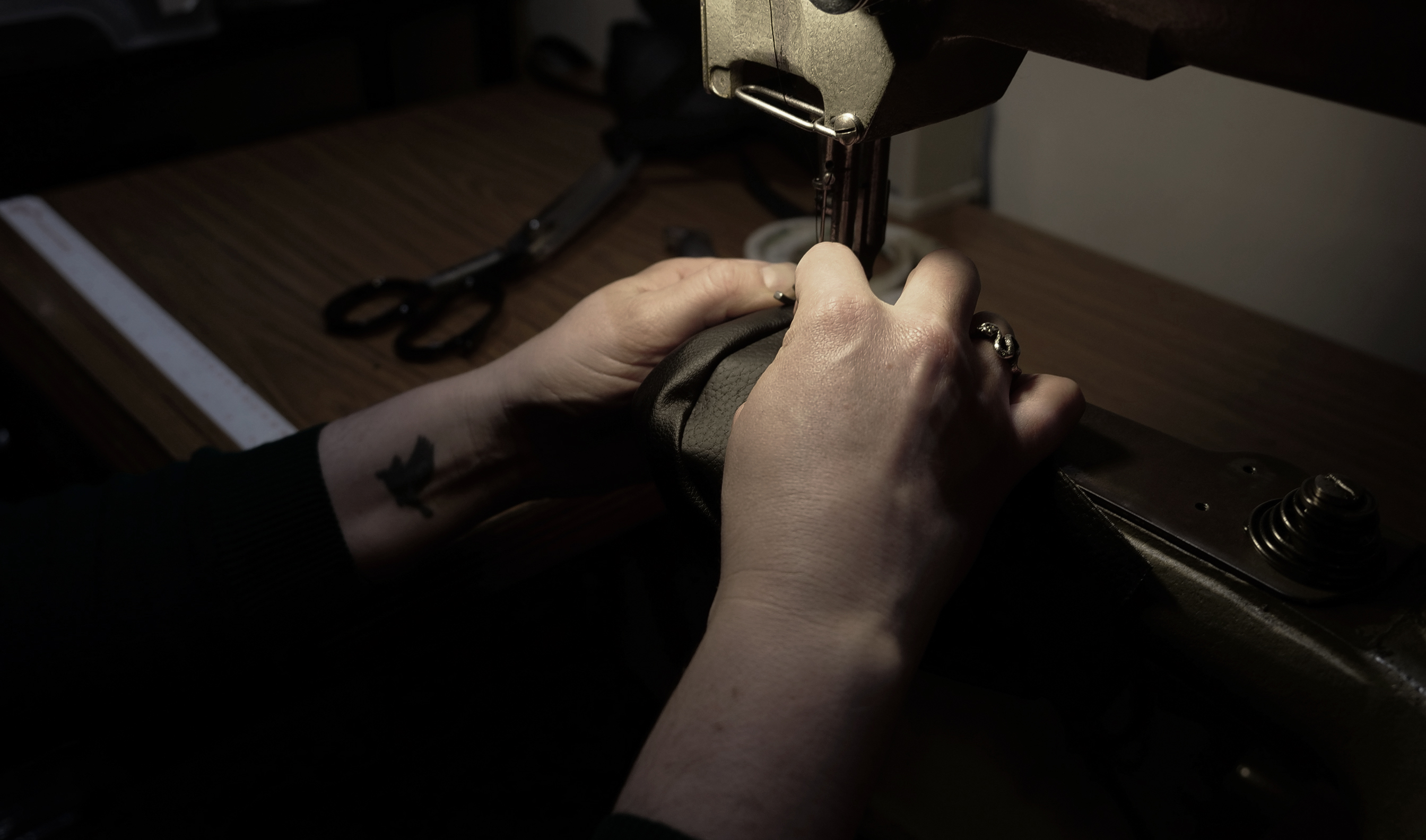 Sewing leather together.